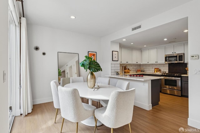 dining space featuring light wood-type flooring