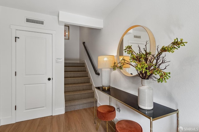 stairs with hardwood / wood-style floors