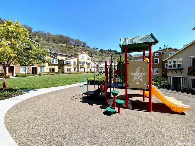 view of jungle gym featuring a lawn