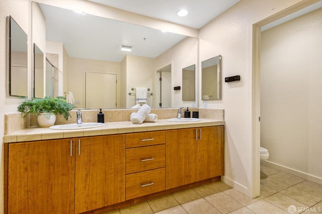 3090 Glascock St Unit 112, Oakland, CA 94601 - bathroom featuring double vanity, tile patterned flooring, toilet, and baseboards