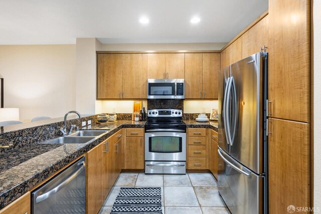 3090 Glascock St Unit 112, Oakland, CA 94601 - kitchen with appliances with stainless steel finishes, a sink, light tile patterned floors, brown cabinetry, and recessed lighting