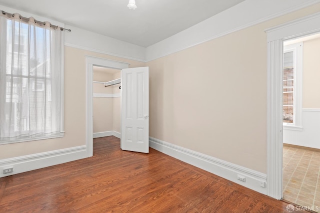 4632 18th St, San Francisco, CA 94114 - unfurnished bedroom with multiple windows, wood finished floors, and a walk in closet