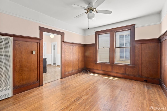 4632 18th St, San Francisco, CA 94114 - unfurnished bedroom featuring a heating unit, wainscoting, light wood-type flooring, and ceiling fan