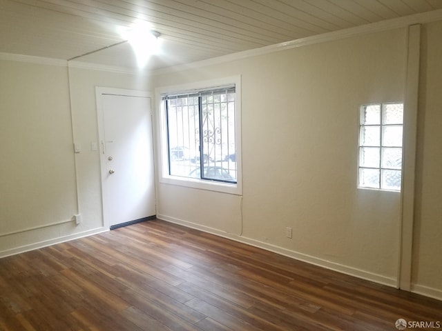 unfurnished room with ornamental molding, a healthy amount of sunlight, and dark hardwood / wood-style flooring