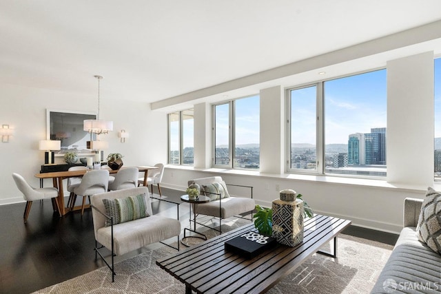 living area featuring a wealth of natural light, a view of city, baseboards, and light wood finished floors