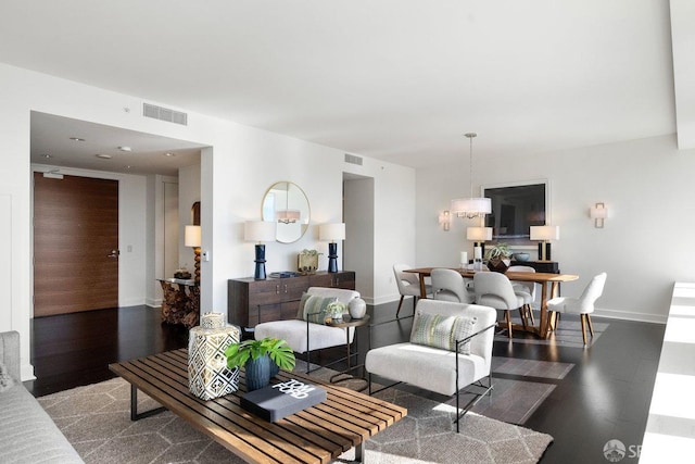 living area featuring baseboards, visible vents, and dark wood-type flooring