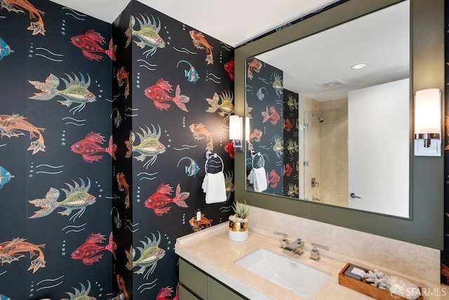 bathroom featuring walk in shower and vanity