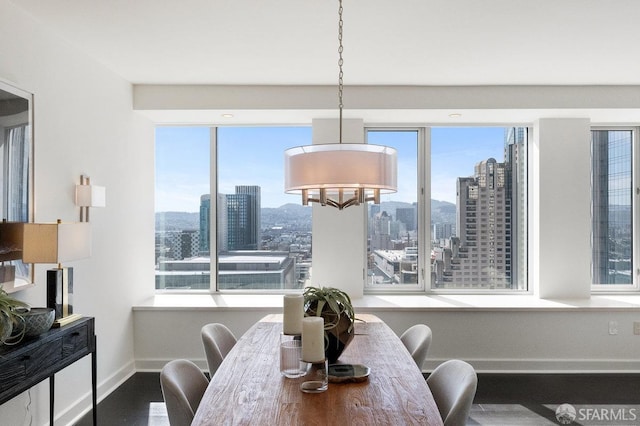 dining area with a view of city and baseboards