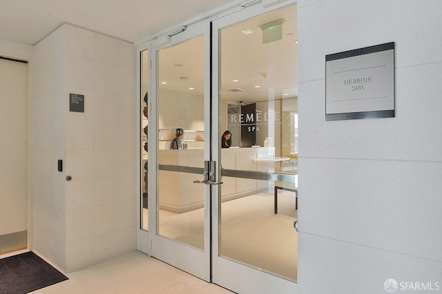 interior space with tile walls and tile patterned floors