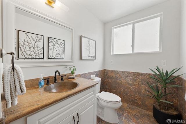 245 Skyline Dr, Daly City, CA 94015 - half bathroom with vanity, stone finish floors, tile walls, and a wainscoted wall