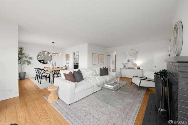 245 Skyline Dr, Daly City, CA 94015 - living room with wood finished floors, a chandelier, and a fireplace