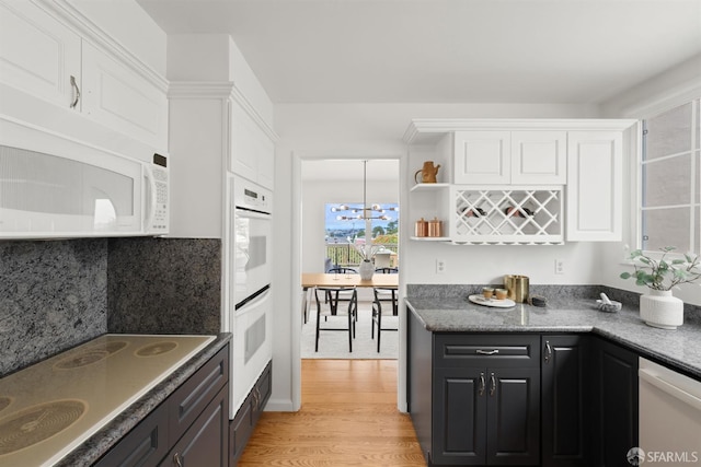 245 Skyline Dr, Daly City, CA 94015 - kitchen with white appliances, white cabinetry, light wood-style flooring, tasteful backsplash, and a chandelier