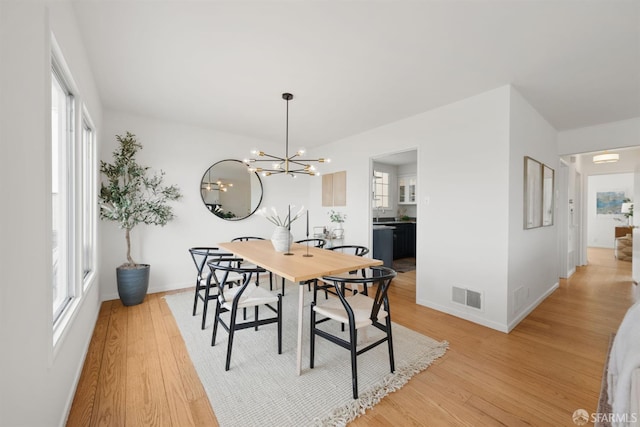 245 Skyline Dr, Daly City, CA 94015 - dining area featuring light wood-style flooring, plenty of natural light, and a chandelier