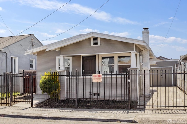 view of front of house with a gate, a fenced front yard, and a chimney