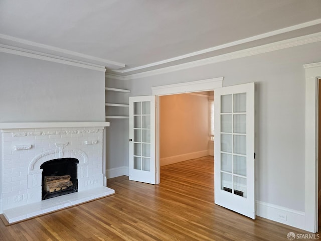 unfurnished living room with french doors, a fireplace, and hardwood / wood-style flooring