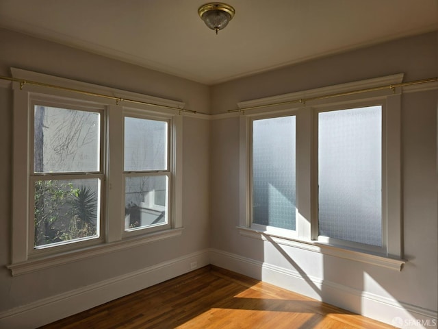 empty room with hardwood / wood-style floors