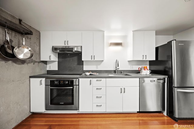 461 2nd St Unit C135, San Francisco, CA 94107 - kitchen featuring appliances with stainless steel finishes, under cabinet range hood, a sink, and dark countertops