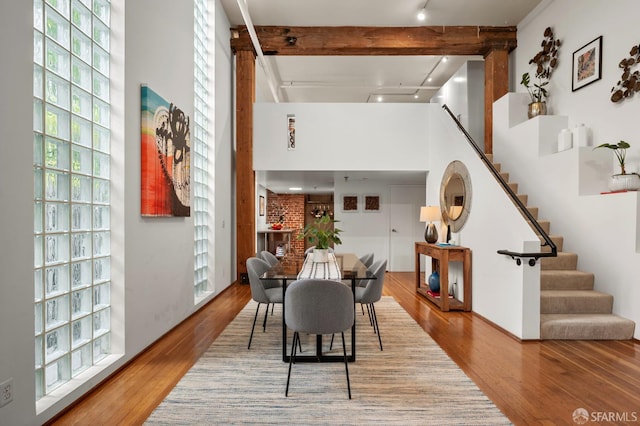461 2nd St Unit C135, San Francisco, CA 94107 - dining space with wood finished floors, beamed ceiling, stairs, and a towering ceiling