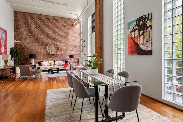 461 2nd St Unit C135, San Francisco, CA 94107 - dining room with brick wall, a high ceiling, wood finished floors, plenty of natural light, and track lighting