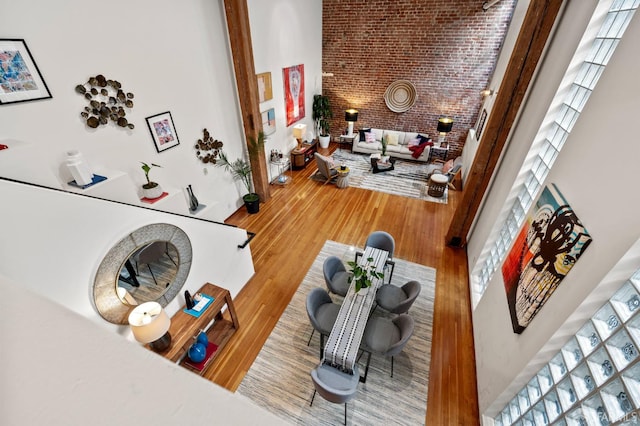 461 2nd St Unit C135, San Francisco, CA 94107 - living area with wood finished floors, a towering ceiling, and brick wall