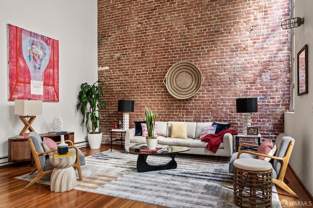 461 2nd St Unit C135, San Francisco, CA 94107 - living area with wood finished floors, brick wall, a towering ceiling, and baseboard heating