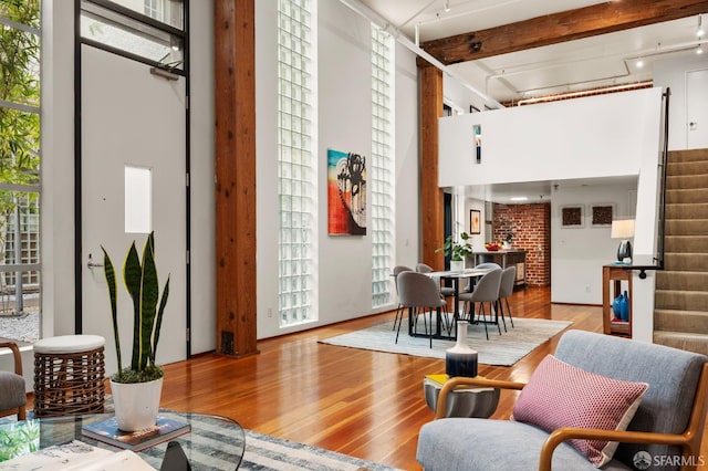 461 2nd St Unit C135, San Francisco, CA 94107 - living area with stairs, wood finished floors, a towering ceiling, healthy amount of natural light, and beamed ceiling