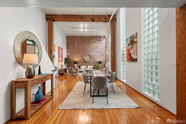 461 2nd St Unit C135, San Francisco, CA 94107 - dining area featuring wood finished floors, brick wall, and rail lighting