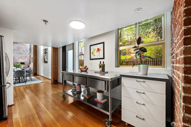 461 2nd St Unit C135, San Francisco, CA 94107 - kitchen with freestanding refrigerator, light wood-style floors, healthy amount of natural light, and white cabinetry
