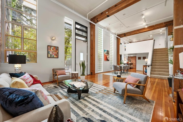 461 2nd St Unit C135, San Francisco, CA 94107 - living room featuring wood finished floors, stairway, track lighting, and a high ceiling