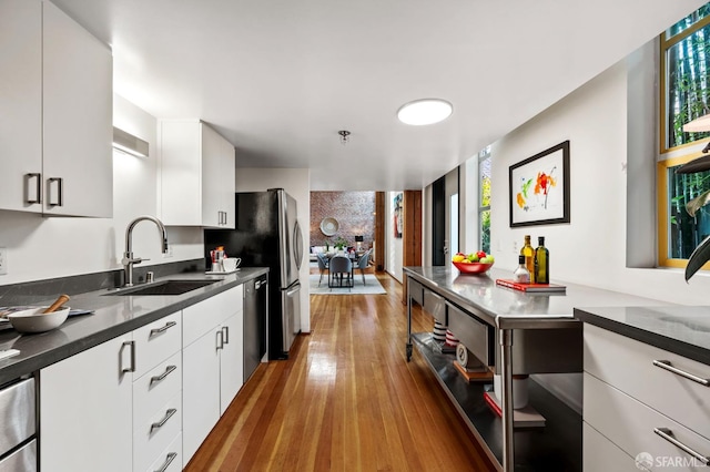 461 2nd St Unit C135, San Francisco, CA 94107 - kitchen featuring a sink, dishwasher, plenty of natural light, and white cabinets