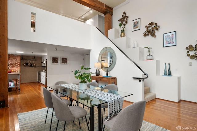 461 2nd St Unit C135, San Francisco, CA 94107 - dining space with stairway, wood finished floors, track lighting, and a towering ceiling
