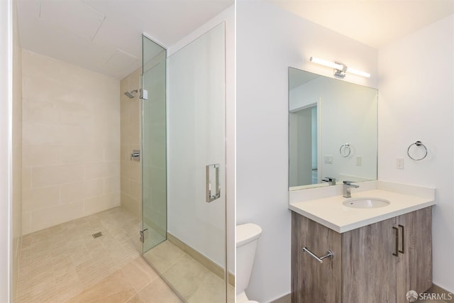 full bathroom featuring a stall shower, vanity, toilet, and tile patterned floors