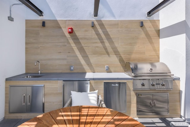 view of patio with outdoor dining area, a sink, and area for grilling