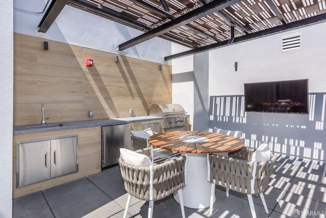 view of patio with a sink, visible vents, exterior kitchen, grilling area, and outdoor dining space