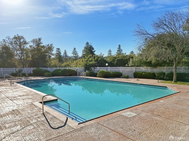 view of swimming pool with a patio area