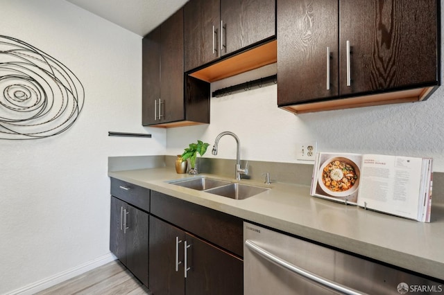 kitchen featuring sink, light hardwood / wood-style floors, dishwasher, and dark brown cabinets