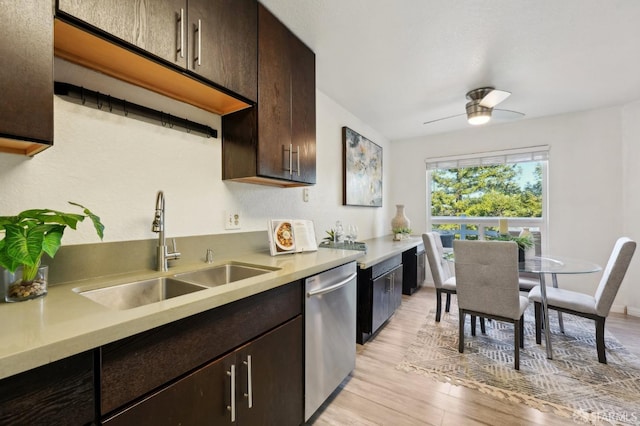 kitchen with stainless steel dishwasher, light hardwood / wood-style floors, ceiling fan, dark brown cabinets, and sink