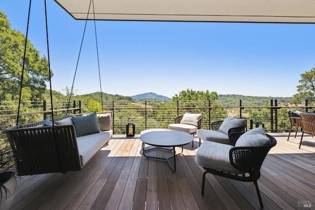 wooden terrace with a mountain view and outdoor lounge area