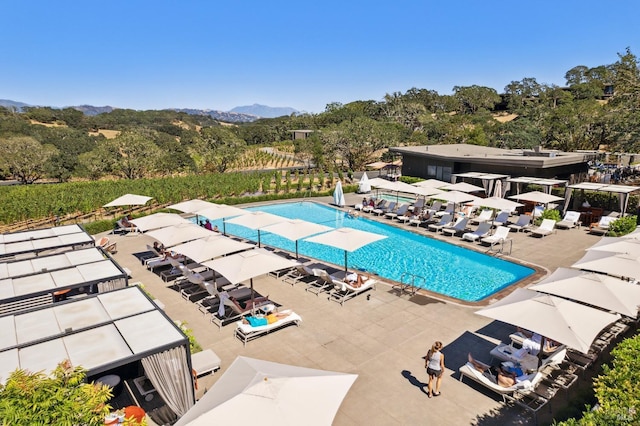 pool featuring a mountain view and a patio