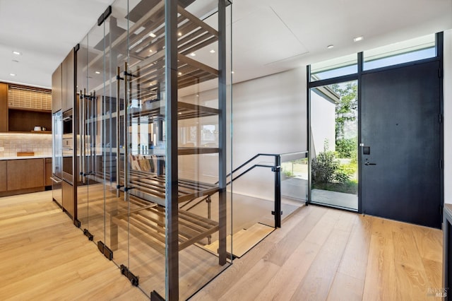 interior space with light wood-type flooring and a wall of windows