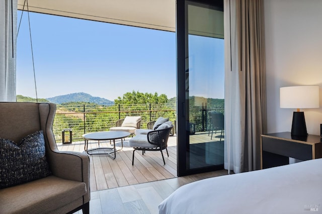 bedroom with a mountain view and wood finished floors