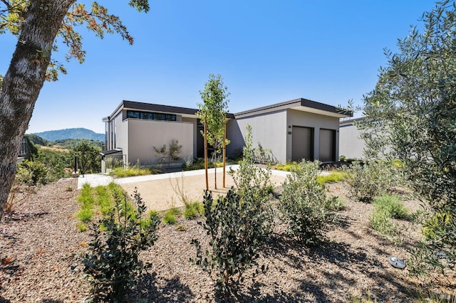 view of front of house with an attached garage and stucco siding