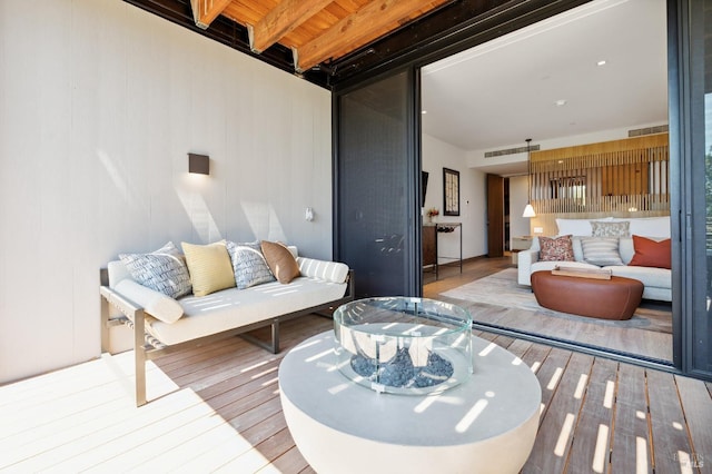 living area featuring visible vents and wood finished floors