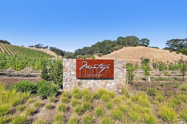 community / neighborhood sign featuring a rural view