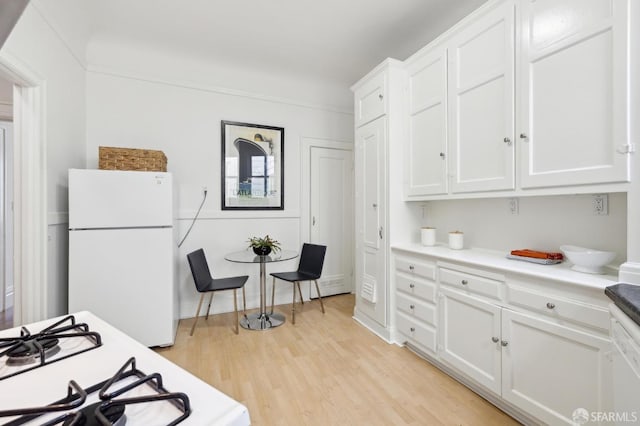1015 Ashbury St Unit 3, San Francisco, CA 94117 - kitchen with white appliances, light wood finished floors, white cabinetry, and light countertops