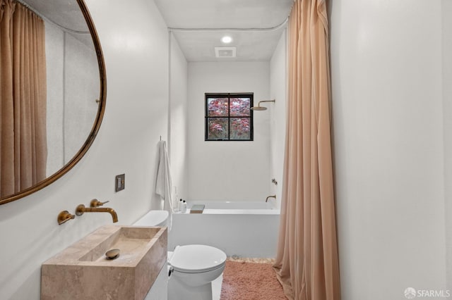 bathroom with visible vents, toilet, and shower / bath combination with curtain