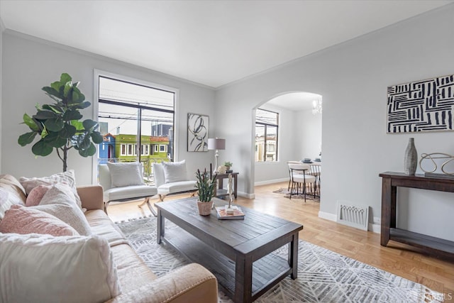 living room with ornamental molding and light parquet floors