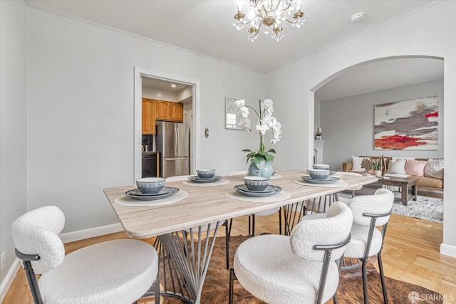 dining room with light hardwood / wood-style floors and a notable chandelier