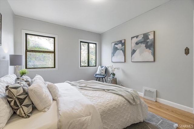 bedroom with hardwood / wood-style flooring