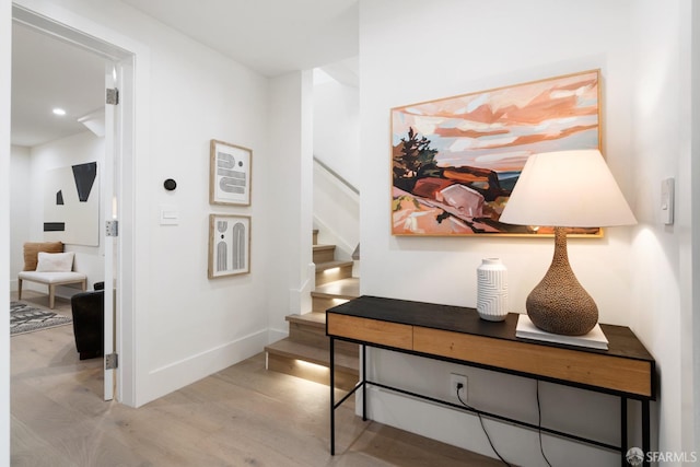 hallway with light hardwood / wood-style floors